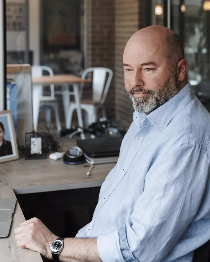 Man sitting at desk starting past the camera